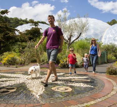 Family walking dog in Outdoor Gardens at Eden Project